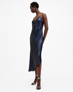 Our 2-in-1 styles are iconic. A maxi length slip dress with v-neck shaping and a refined silhouette sits underneath. It's made from a luxury hammered satin fabric crafted from partly recycled materials. On top is a cropped relaxed-fit sweater made from a soft yarn with a sparkle running through. The innovatively ribbed and panelled design is complete with a high-low hem. The Amos is clean and minimal – wear them together or apart.  2-in-1 style This dress is designed to a regular fit The sizing Summer Fitted Midi Dress By Allsaints, Spring Midi Dress By Allsaints, Chic Summer Midi Dress By Allsaints, Chic Allsaints Summer Midi Dress, Chic Allsaints Midi Dress For Spring, Chic Allsaints Spring Midi Dress, Chic Spring Midi Dress By Allsaints, Allsaints Chic Spring Midi Dress, Allsaints Fitted Midi Dress