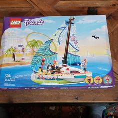 the box is open to show it's contents and features a sailboat with people on it