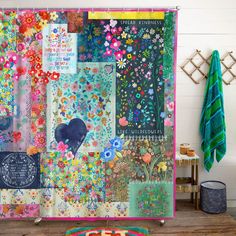 a colorful shower curtain covered in lots of different types of flowers and hearts on it