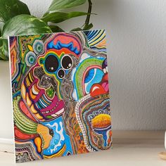 a colorful abstract painting on a white background art boarder next to a potted plant