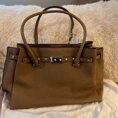 Michael Kors Handbag. Taupe/Tan It’s A Close To Being Nwt As You Can Get. Kept In A Dust Bag And Used For A Special Occasion Event. There Is A Center Zippered Pocket/Divider. There Are No Stains, Marks Or Cuts On This Beauty! Beige Rectangular Satchel With Branded Hardware, Brown Satchel With Branded Hardware And Double Handles, Brown Satchel With Branded Hardware For Office, Brown Office Satchel With Branded Hardware, Taupe Satchel With Gold-tone Hardware For Travel, Brown Top Handle Satchel With Metal Hardware, Classic Taupe Bags With Gold-tone Hardware, Camel Satchel With Gold-tone Hardware For Daily Use, Everyday Camel Shoulder Bag With Gold-tone Hardware