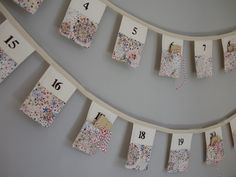 a number line with numbers on it hanging from the wall and pinned to clothes pins