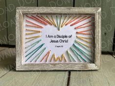 a white frame with colored crayons in it and a bible verse on the front