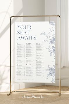 the seating chart for your seat awaits in blue and white flowers on a gold frame