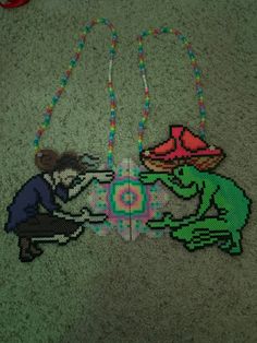 two beaded animals are playing with each other on the floor in front of some beads