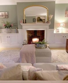 a living room filled with furniture and a fire place in the middle of a room