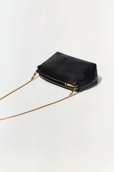 PRE-FALL 2024 WOMEN'S COLLECTION The Rola Camera Bag in Black. With a sleek design that combines modern style with timeless elegance, this bag features a removable shoulder strap chain for versatility, and zipper closure to ensure your essentials are safely stored. Modern Clutch Bag With Zipper Closure, Versatile Evening Bag With Zipper Closure, Minimalist Work Bags With Gold-tone Hardware, Elegant Box Bag With Chain Strap For Everyday Use, Minimalist Workwear Bags With Gold-tone Hardware, Chic Evening Box Bag With Chain Strap, Evening Crossbody Box Bag With Zipper Closure, Chic Crossbody Box Bag With Zipper Closure, Evening Crossbody Bag With Zipper Closure