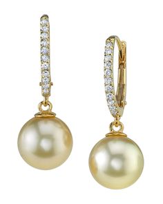 a pair of earrings with pearls and diamonds on the hoop, set in yellow gold