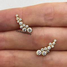 Bezel Set Unique Earrings, Cluster Winged Diamond Earrings, Round Cut Moissanite Anniversary Earrings Gift, 14k Gold Ear Climber Earrings  ✹✹𝐖𝐞𝐥𝐜𝐨𝐦𝐞 𝐭𝐨 𝑻𝒉𝒆𝑩𝒂𝒏𝒅𝒔𝑺𝒉𝒐𝒑✹✹ ★ 𝑺𝒕𝒐𝒏𝒆𝒔 𝑫𝒆𝒕𝒂𝒊𝒍𝒔 ★ ● Stone Shape:- Round Cut ● Stone Type:- Simulated Diamond, Moissanite, Lab-Diamond & Natural Diamond ● Stone Size:- 3.50 mm & 3 mm & 2.50 mm  ● Color:- DEF ● Clarity: VVS-VS ● Cut Grade: Excellent ● Making Process: Handmade - Crafted by our experienced team ★ 𝑰𝒕𝒆𝒎 𝑫𝒆𝒕𝒂𝒊𝒍𝒔:- ☛ Metal Purity: Solid Gold (10KT, 14KT, 18KT); Silver(925 Sterling, 935 Argentium), 950 Platinum ☛ Metal Tone: Yellow, White, Rose ☛ Stamp/Hallmark: Yes ★ 𝑪𝒖𝒔𝒕𝒐𝒎𝒊𝒛𝒂𝒕𝒊𝒐𝒏:- ☛ Customized Design Jewelry. ☛ All cuts which you dream to make with moissanite. ☛ Updating every step of you Cluster Earrings Studs, Gold Ear Climbers, Ear Climber Earrings, Ear Climbers Earrings, Diamond Cluster Earrings, Ear Climber, Yellow Gold Earrings, Earrings Round, Climber Earrings