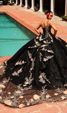 Long black quinceanera ball gown with gold lace embroidery and 3D floral details. Gold And Black Dresses, Halter Ball Gown, Quinceanera Collection, Debutante Ball, Tulle Balls, Quince Dress, Gown Skirt, Quinceanera Dress, Ball Gown Skirt