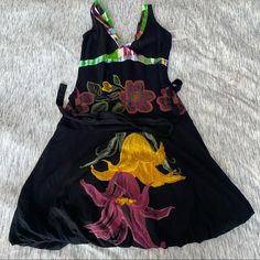 Gorgeous Cotton Black Dress With Floral Embroidery Waist Tie Bubble Hem Skirt Sleeveless Dress With Multicolor Embroidery And Embroidered Hem, Cotton Black Dress, Multicolor Embroidered Floral Mini Dress, Black Floral Embroidered Beach Dress, Multicolor Embroidered Floral Print Mini Dress, Dress With Floral Embroidery, Desigual Dress, Black Cotton Dresses, Dresses Beautiful