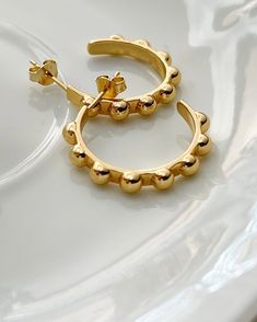 The Studded Gold Hoops are our new Fall Favorites! The Rich golden 18k gold sets the tone for Fall. 18kt gold plated silver one inch hoops. Fall Favorites, One Inch, Gold Hoops, Gold Set, Gold Plated Silver, Silver Plate, Gold Bracelet, 18k Gold, Gold Plate