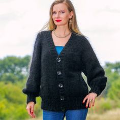 "----------READY TO SHIP by SuperTanya---------- Brand: SuperTanya; Style: hand knitted cardigan; Material: premium class soft mohair; Color: Black Design: V neck thick mohair cardigan Size & Measurements of the cardigan: Body length, measured from the shoulder top to the bottom end: 25.6\" / 65 cm; Chest width, measured at the back, between the underarms: 22.4\" / 57 cm; Sleeve length, measured from the neckline to the end of the cuff: 29.5\" / 75 cm *All measurements are taken with the item la Black Mohair Sweater For Winter, Black Mohair Winter Sweater, Cozy Black V-neck Sweater Coat, Black Mohair Sweater For Fall, Black Mohair Long Sleeve Sweater, Black Long Sleeve Mohair Sweater, Black Knitted Cardigan For Fall, Cozy Black Mohair Sweater, Black Hand Knitted Outerwear For Fall