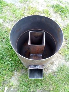 a metal bucket sitting in the grass