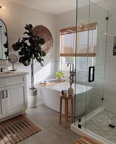 a bathroom with a tub, sink and shower in it's own area next to a window