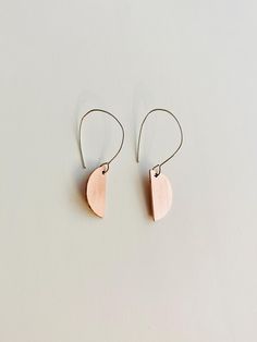 Half circle dangle earrings made from a sheet of copper metal. Hangs from a hand-formed silver earring wire. Minimalist Silver Copper Earrings, Adjustable Minimalist Copper Earrings, Minimalist Copper Drop Earrings, Minimalist Copper Earrings With Ear Wire, Minimalist Copper Earrings For Everyday, Minimalist Copper Earrings For Everyday Wear, Minimalist Everyday Copper Earrings, Nickel Free Minimalist Half Moon Earrings, Minimalist Nickel-free Half Moon Earrings