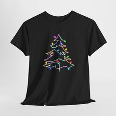 A festive Christmas Light Christmas Tree tee that is perfect for the holiday season. The design gives off a cozy and joyful vibe, making it a great addition to your winter wardrobe. This tee is relevant to anyone looking to spread Christmas cheer and celebrate the holiday season. Product features - Shoulder tape for added stability - Made with specially spun fibers for a strong and smooth fabric - Classic fit for a comfy wear - Ethically grown and harvested US cotton - Tear-away label for a scra Xmas Tree Lights, Holiday Graphic Tees, Christmas Tree Lights, Christmas Clothing, Tee Tree, Tree Lights, Christmas Tree Lighting, Christmas Cheer, Clothes Gift