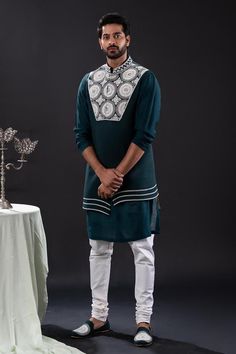 Peacock green sleeveless asymmetric bundi with bloom embroidery using pearls and beads. Paired with long sleeves plain kurta and matching churidar.
Components: 3
Pattern: Embroidered
Type Of Work: Pearl Bloom
Neckline: Band Collar
Sleeve Type: Bundi: Sleeveless, Kurta: Long
Fabric: Mal Cotton, Moss Crepe, Cotton Lycra
Color: Green
Other Details: 
Approx weight: 2kgs
Poly lining
Occasion: Mehendi and Puja, Sangeet - Aza Fashions Sleeveless Cotton Kurta With Zari Work, Green Sleeveless Kurta With Resham Embroidery, Green Sleeveless Resham Embroidered Kurta, Designer Sleeveless Kurta For Transitional Season, Green Sleeveless Embroidered Traditional Wear, Festive Green Nehru Jacket For Reception, Sleeveless Kurta With Intricate Embroidery For Eid, Green Sleeveless Kurta For Diwali, Sleeveless Kurta For Eid Reception