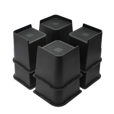 four black plastic containers sitting on top of each other