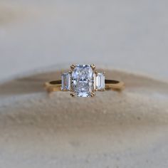 an engagement ring with three baguets on it