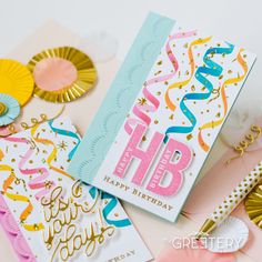 a birthday card with confetti and streamers on it, next to other cards