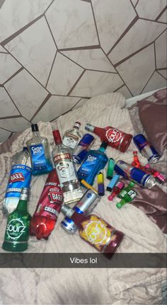 several different types of alcohol on a bed