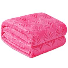 the pink blanket is folded on top of each other