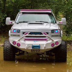 the front end of a silver truck in water