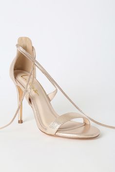 Top off your LBD with a choker and the Lulus Aimee Champagne Metallic Lace-Up Heels! These sexy single sole heels, made from luxe metallic fabric, have a peep-toe upper, strappy vamp, and long laces with gold aglets that tie around the ankle. Fit: This garment fits true to size. 4. 25" wrapped stiletto heel. Cushioned insole. Nonskid rubber sole. All vegan friendly, man made materials. Imported. Lulus | Aimee Champagne Metallic Lace-Up Heels | Size 9. Champagne Ankle Strap Heels For Night Out, Metallic Wrapped Heel Gala Heels, Metallic Heels With Wrapped Heel For Gala, Metallic Wrapped Heel Heels For Gala, Chic Ankle Strap Heels With Shimmer, Chic Shimmer Heels For Night Out, Metallic Heels With Wrapped Heel For Evening, Evening Metallic Heels With Wrapped Heel, Gold Shimmer Heels For Gala