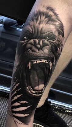 a man's leg with an angry gorilla tattoo on his arm, and the image is