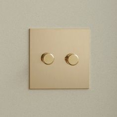 two dimmers on a white wall with one light switch facing the other way