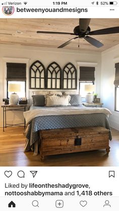 a bedroom with a bed, dresser and ceiling fan in the middle of the room