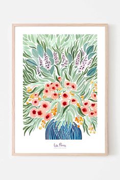 a print with flowers in a blue vase on a white wall next to a wooden frame