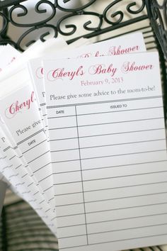 three baby shower games sitting on top of a metal rack next to a basket with flowers