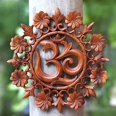 an intricately carved wooden decoration on the side of a tree