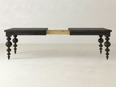 two black tables with wooden legs on each side