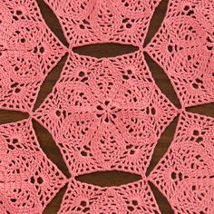 pink crocheted doily on wooden surface