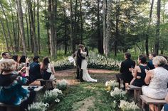 a couple is getting married in the woods