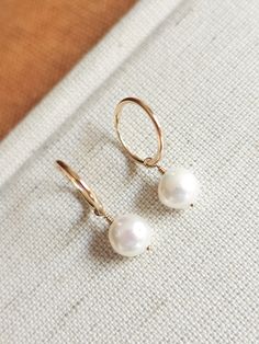 These dainty freshwater pearl hoops are the perfect accessory to complete that minimalist modern look! Great to give as a gift or to treat yourself! --------------------------- D E T A I L S * Earrings are made out of 14k gold-fill wire - Great for those sensitive to specific metals - Lightweight for easy wear * Hand-shaped rounded wire (14mm in diameter - 1.20mm thick) * Pearls measure 8mm * Ethical sourcing of all materials * Packaged neatly + securely in a reusable drawstring bag - ready to g Minimalist Teardrop Hoop Earrings With Pearl Charm, Minimalist Pearl Dangle Huggie Earrings, Minimalist Pearl Earrings For Everyday, Minimalist 14k Gold-filled Hoop Earrings With Pearl Charm, Minimalist 14k Gold Filled Small Hoop Pearl Earrings, Minimalist Everyday Pearl Earrings, Delicate Hoop Earrings With Pearl Charm For Everyday, Delicate Everyday Hoop Earrings With Pearl Charm, Everyday Hoop Pearl Earrings With Ear Wire