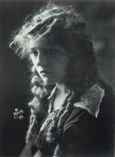 an old black and white photo of a woman