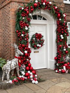 two christmas wreaths on the front door of a house decorated with red and white ornaments