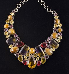 Vintage Bali sterling silver bib necklace set with Ametrine, Amethyst, Citrine, Tiger Eye and Red Cut Glass Stones Necklace is somewhere around 20 inches long, difficult to measures Elegant Multicolor Citrine Jewelry, Multicolor Amethyst Multi-stone Necklaces, Multicolor Amethyst Multi-stone Necklace, Multicolor Amethyst Necklaces With Gemstone Accents, Multicolor Citrine Gemstone Jewelry, Luxury Multicolor Amethyst Jewelry, Multicolor Amethyst Pendant Jewelry, Multicolor Multi-stone Amethyst Jewelry, Tibetan Buddha