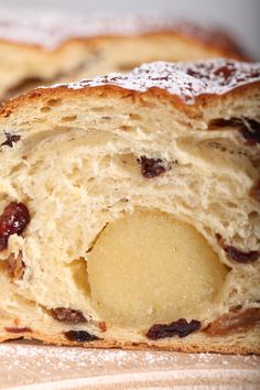 two pieces of bread with raisins and powdered sugar