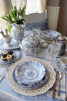 a table set with blue and white china