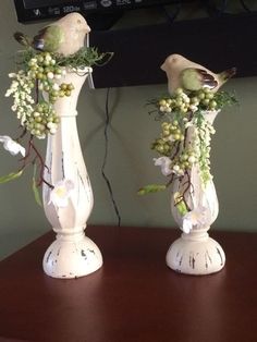 two white vases with flowers and birds on them