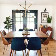 a dining room table with blue chairs around it