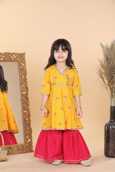 Combine tradition and fashion in this beautiful kurta set from Adiva - perfect for your little girl's next big event. Paired with flats and bangles. This ethnic suit consists of a block printed fit and flared Anarkali Kurti and a pair of sharara. The soft cotton fabric makes the dress most comfortable and stylish, sharara set has a flared bottom hem. Yellow Traditional Drape Dress For Puja, Festive Yellow Dress For Puja, Yellow Anarkali Dress For Puja, Festive Cotton Frock, Bollywood Style Yellow Dress For Puja, Yellow Bollywood Dress For Puja, Yellow Dress For Puja And Navratri, Festive Cotton Dress For Puja, Cotton Dress For Diwali Puja