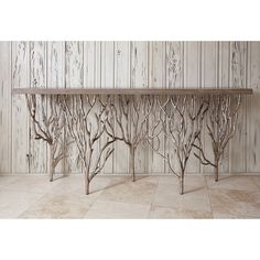 a wooden table with metal branches on it