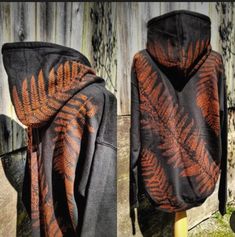 the hoodie has an orange and black fern print on it's front, and back