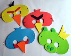 four different colored masks with faces and numbers on them, each one has a face